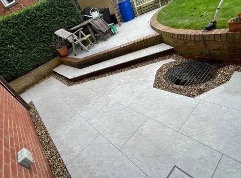 a patio with a fire pit in the middle of it