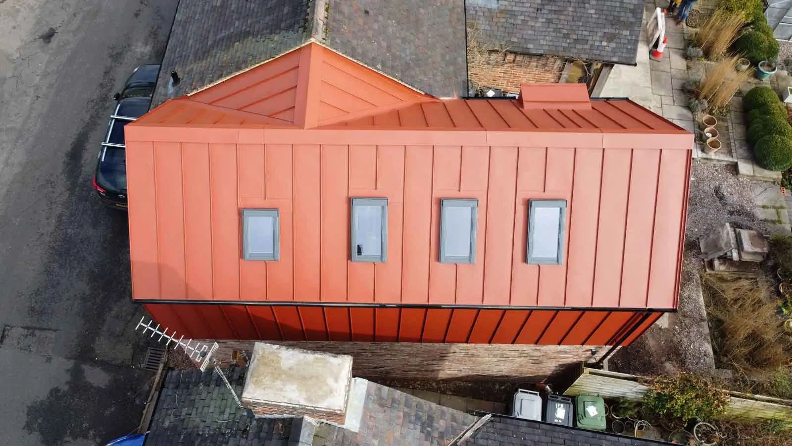 an aerial view of a house with a red roof