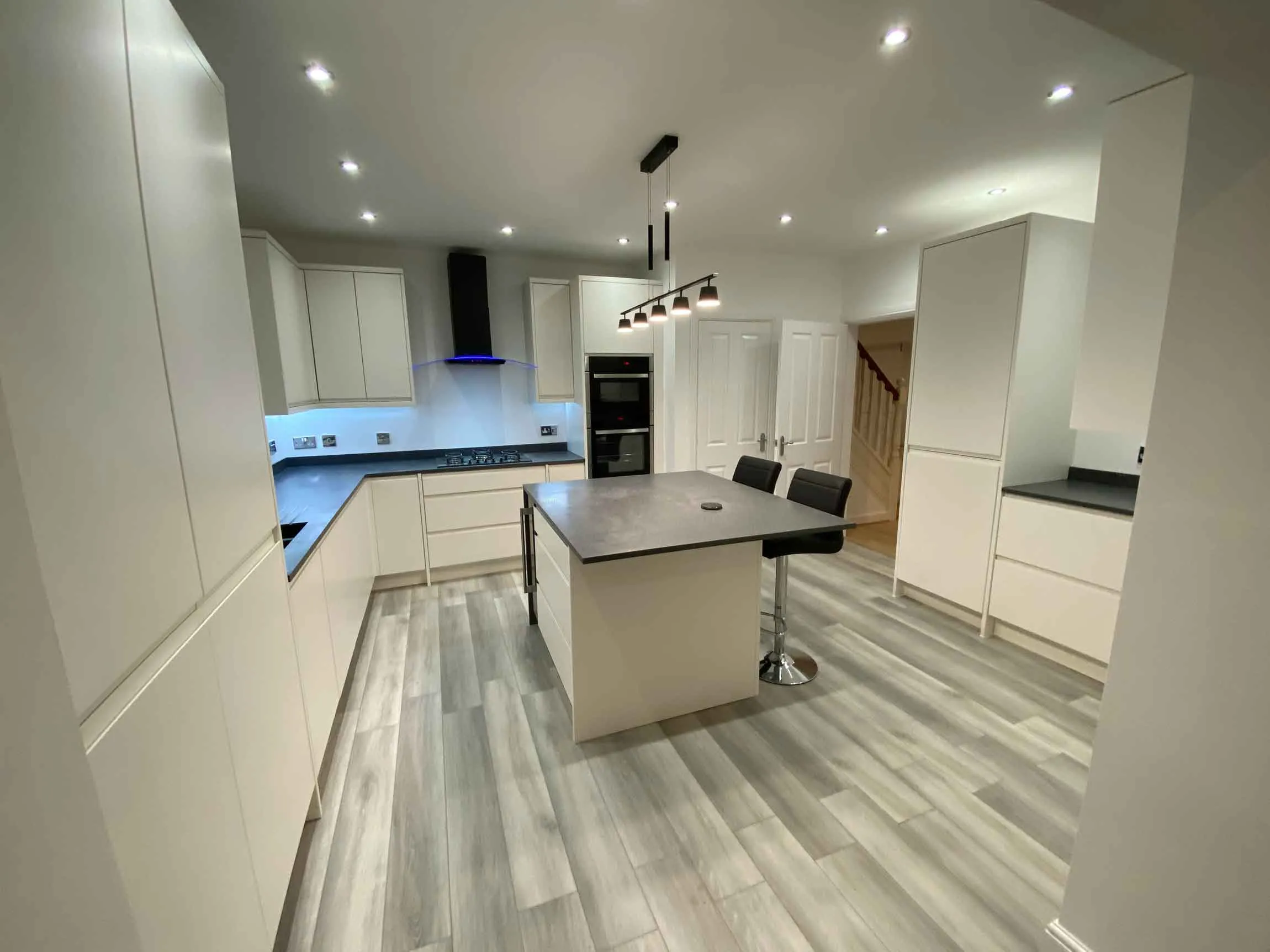 a large kitchen with a center island in the middle of the room