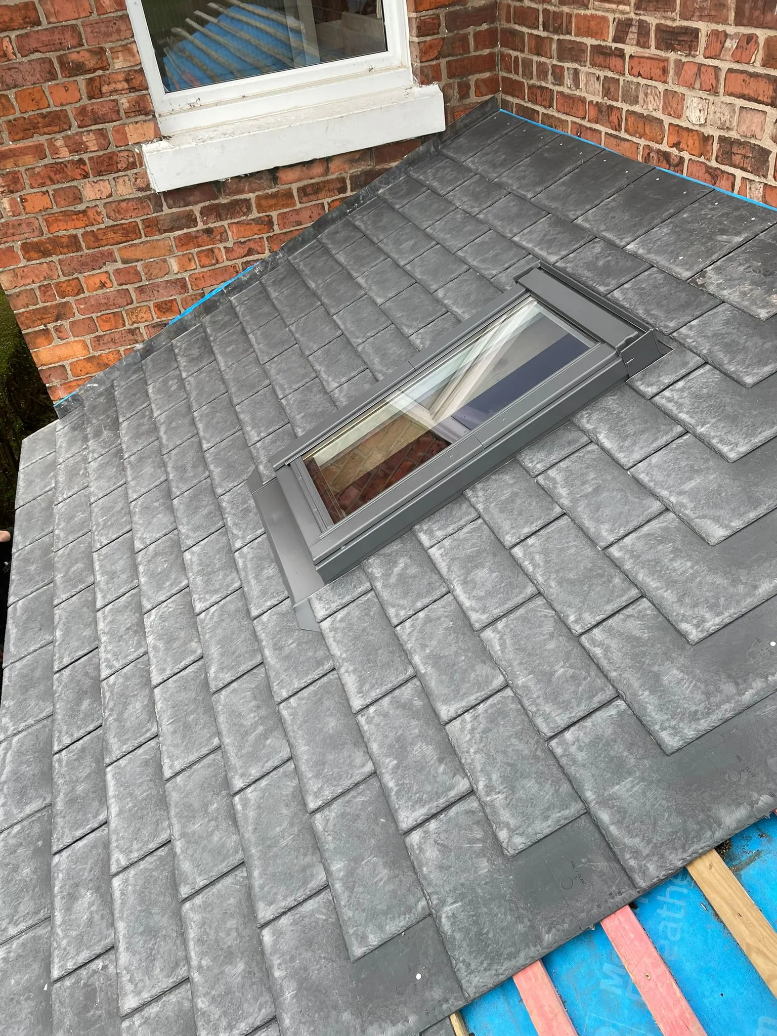 a flat roof with a small window on top of it