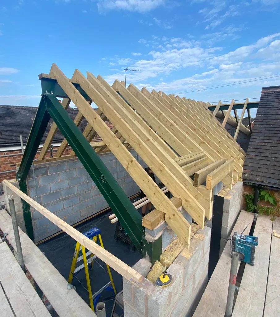 a house being built with a wooden roof